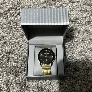 Gold watch with sticker/tag